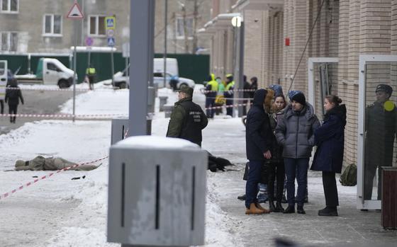 Investigators work at the place where Lt. General Igor Kirillov, the head of Russia's Nuclear, Biological, and Chemical Defence Forces and his assistant, seen at left, were killed by an explosive device planted close to a residential apartment's block in Moscow, Russia, Tuesday, Dec. 17, 2024. (AP Photo)