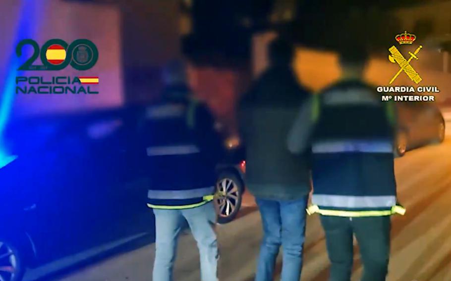 A screenshot from a Spanish national police video posted Feb. 5, 2025, shows officers leading a man 