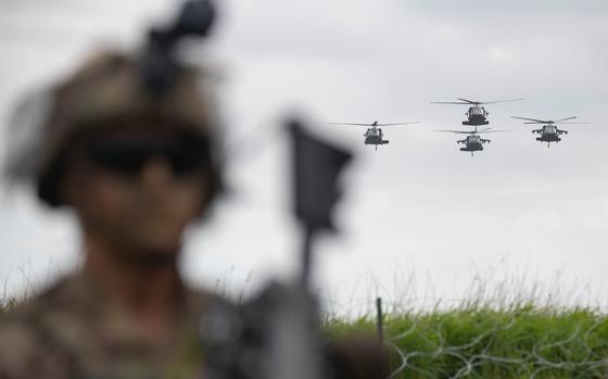 Helicopters supporting the 101st Airborne Division fly over Carentan, France, on June 2, 2024, as part of D-Day commemoration events. The 101st Airborne Division conducted an air assault demonstration in Normandy.