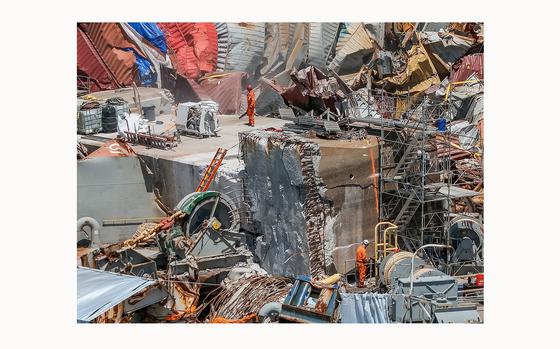 Salvage experts continue to clear the large amount of wreckage on the bow of the container ship Dali, twelve weeks after the collapse of the Francis Scott Key Bridge, on June 19, 2024, in Baltimore. (Jerry Jackson/Baltimore Sun/TNS)