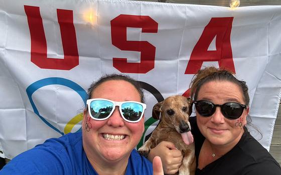 Chelsea Talley, left, a physical education teacher at Brussels Unit School in Brussels, and her wife Stephany Casillas, a secretary at the school, pose with their dog Cutty. Talley and Casillas are traveling to Lille, France, to watch the U.S. women's basketball team face Japan on July 29 in the Paris Olympics tournament.