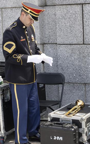 Sgt. 1st Class Kevin Paul of the U.S. Army Band prepares to play Taps at the 20th anniversary celebration of the National World War II Memorial in Washington, May 25, 2024.