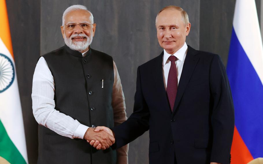 Russian President Vladimir Putin, right, and Indian Prime Minister Narendra Modi shake hands prior to meeting in Samarkand, Uzbekistan, in September 2022.