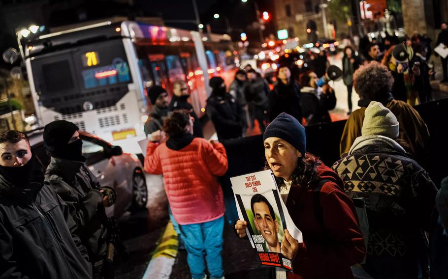 Protesters hold up signs for hostages in Gaza and cause traffic congestion during a march in Jerusalem on Wednesday, Jan. 24, 2024, organized by women groups meant to raise awareness about the plight of female hostages still in Gaza.