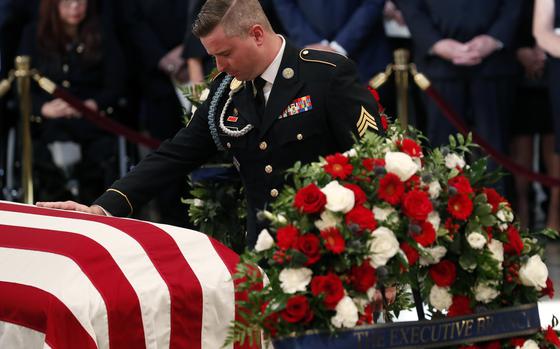 FILE - Jimmy McCain, son of Sen. John McCain, R-Ariz., pauses at his father's casket during ceremonies honoring McCain at the U.S. Capitol Rotunda in Washington, Aug. 31, 2018. Jimmy McCain has registered as a Democrat and will vote for Kamala Harris for President in 2024. (Kevin Lamarque/Pool Photo via AP)