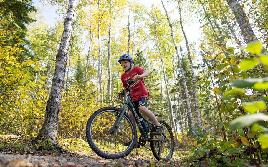 David Erickson, 10, mountain-bikes through the Split Rock Wilds mountain-bike trail system in Two Harbors, Minn., on Oct. 3, 2023. The system includes more than 20 miles of easy to very difficult trails that rise up to 500 feet over Lake Superior and Hwy. 61, culminating in stony clifftops overlooking pines, aspens and the Great Lake.