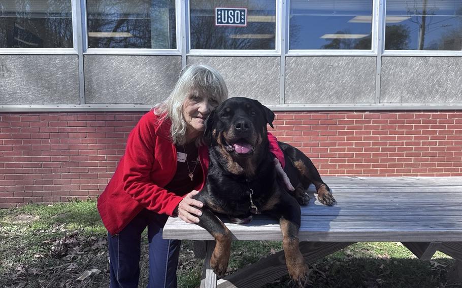 A woman hugging her dog.