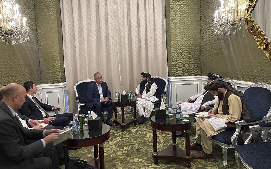 Zabihullah Mujahid, the chief spokesman for the Taliban government who leads the Taliban delegation, center right, speaks with Uzbekistan Presidential Envoy to Afghanistan Ismatullah Irgashev, during a meeting in Doha, Qatar, Sunday, June 30, 2024. 