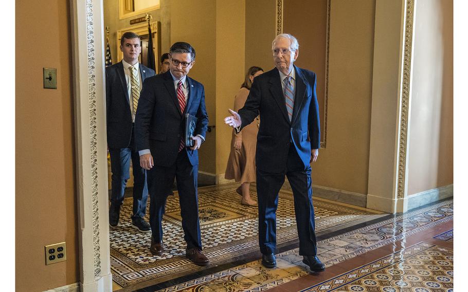 House Speaker Mike Johnson and Senate Minority Leader Mitch McConnell head toward a Senate Republican lunch in November, 2023.