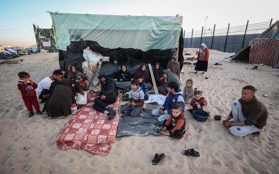 Shahinaz Nofal’s family gathers next to their tent south of Rafah on Jan. 21, 2024. 