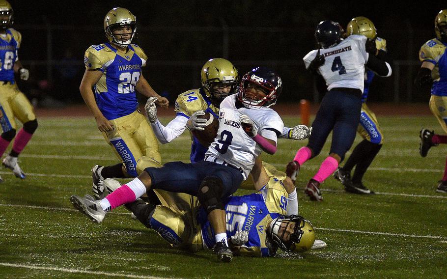 Teagan McConville and Tyler Truesdell combine for a tackle.