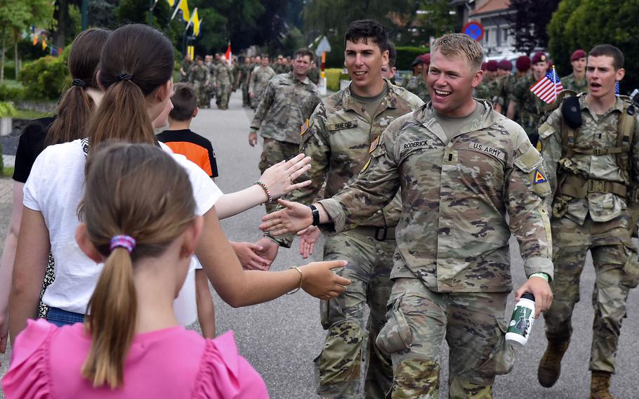 Army soldier greets children