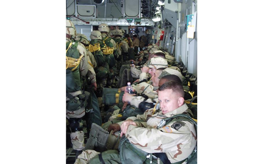 Col. Bill Mayville, lower right, the commander of the 173rd Airborne Brigade, on a C-17 transport plane with his troops Wednesday at Aviano Air Base. The 173rd, which hasn’t participated in a combat jump since the Vietnam War, had 1,000 soldiers parachute into northern Iraq. Mayville was set to be the first one off the first plane.