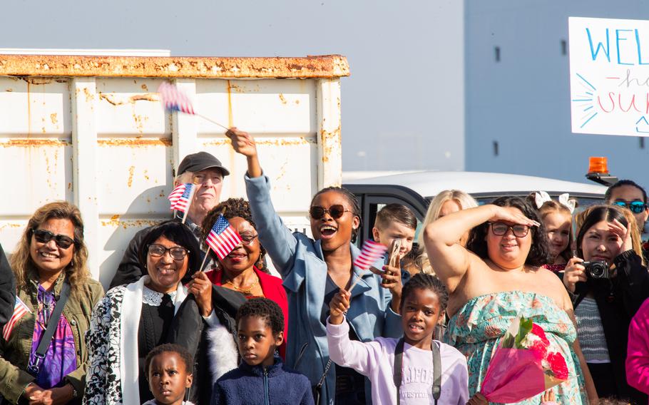 Family and loved ones hold cheer during a homecoming ceremony for the USS Stockdale