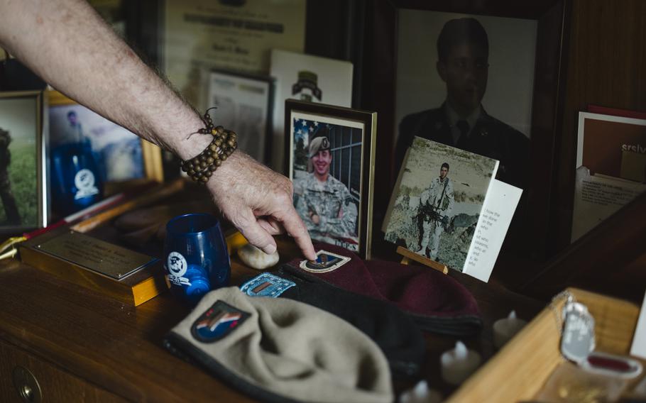 Andy Weiss displays the different levels of beret his son Daniel earned during his service. 