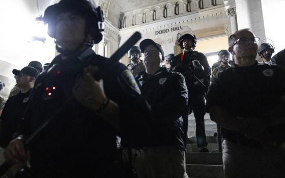 University of California Police officers face pro-Palestinian protesters outside Dodd Hall in the University of California Los Angeles (UCLA) in Los Angeles, June 10, 2024. Several protesters were arrested by UCLA police following a new attempt to set up an encampment on the University campus.  (Etienne Laurent/AFP/Getty Images/TNS)