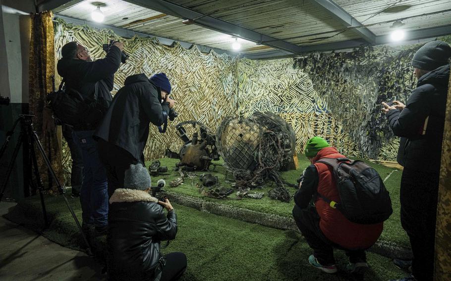 Journalists at a center for forensic analysis in undisclosed location in Ukraine on Nov. 24, 2024, film fragments of what authorities in Kyiv described as a Russian hypersonic missile.