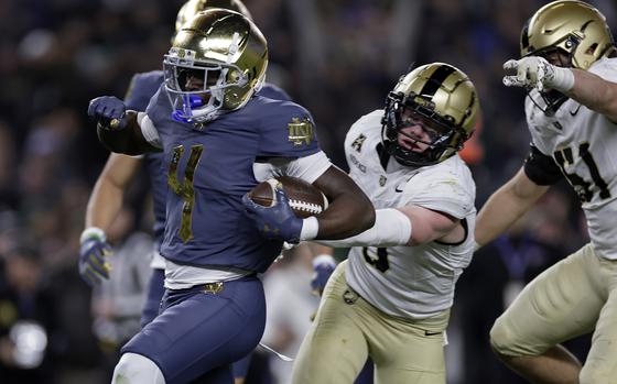 Notre Dame running back Jeremiyah Love scores a touchdown during the first half of an NCAA college football game against Army at Yankee Stadium on Saturday, Nov. 23, 2024, in New York. (AP Photo/Adam Hunger)