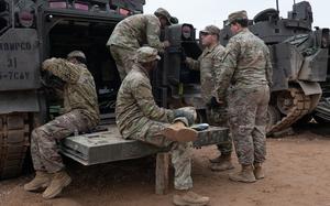 U.S. soldiers assigned to the 5th Squadron, 7th Cavalry Regiment do maintenance work on an Armored Multi-Purpose Vehicle at Camp Reedo, Estonia, March 13, 2025.