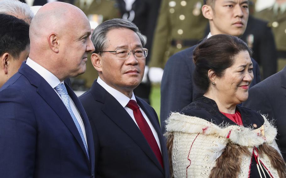 Chinese Premier Li Qiang, centre, stands with New Zealand Prime Minister Christopher Luxon, left, and New Zealand Governor General Dame Cyndi Kiro during the official welcome ceremony in Wellington, New Zealand, Thursday, June 13, 2024. Li has arrived in New Zealand at the start of a weeklong tour that also includes Australia and Malaysia.