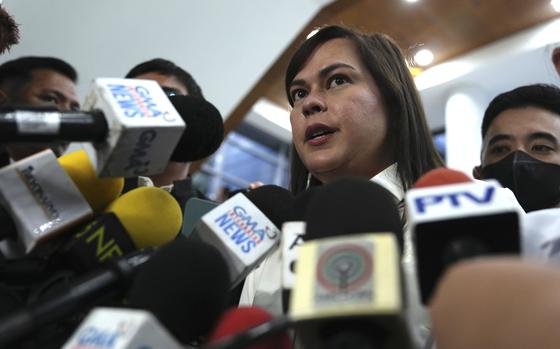 Philippine Vice President Sara Duterte speaks while surrounded by microphones from reporters in Quezon City, Philippines, Nov. 25, 2024.