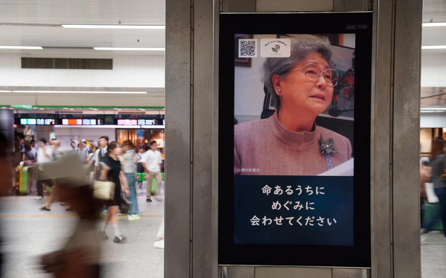 Yokohama Station commuters pass video ads featuring the family of North Korean abductee Megumi Yokota on Aug. 21, 2024.