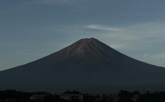 FILE - Mount Fuji in the early morning sunlight is seen from Lake Kawaguchi, Japan, on Aug. 7, 2019. (AP Photo/Jae C. Hong, File)