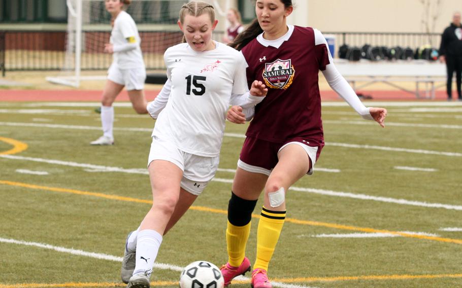 E.J. King's Madylyn O'Neill and Matthew C. Perry's Sophia Nye scuffle for the ball during Saturday's DODEA-Japan girls soccer match. The Cobras and Samurai played to a 2-2 draw.