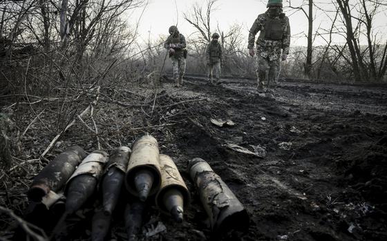 Ukrainian servicemen collect damaged ammunition on the road at the front line near Chasiv Yar town, in Donetsk region, Ukraine, Ukraine, Friday, Jan. 10, 2025. (Oleg Petrasiuk/Ukraine's 24th Mechanised Brigade via AP)