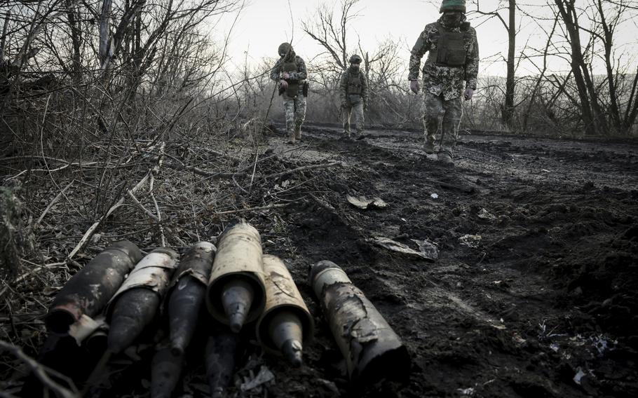 Ukrainian servicemen collect damaged ammunition on the road 