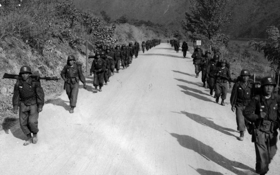 Advancing Infantrymen march along a road on their way to reinforce main battle positions during Operation Killing Zone. The exercise was a test of combat effectiveness during a chemical, biological and radiological war. 