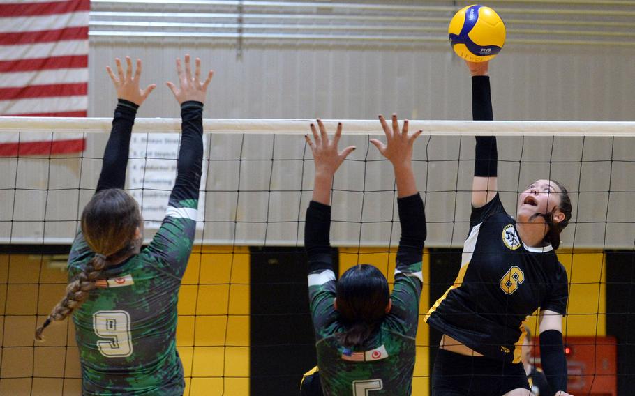 Kadena's Samantha Kehe spikes against Kubasaki's Hailey Brassard and Rameghlyn Doctolero during Tuesday's Okinawa girls volleyball match. The Panthers won in straight sets.