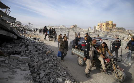 Displaced Palestinians leave parts of Khan Younis as they go back to their homes in Rafah, southern Gaza Strip, Sunday, Jan. 19, 2025. (AP Photo/Jehad Alshrafi)