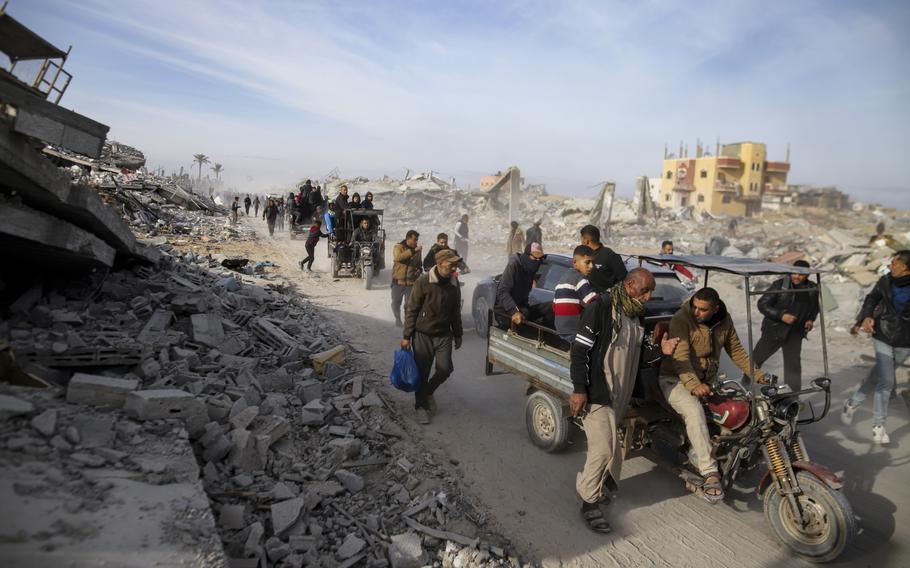 People carry their belongings on a road in the Gaza Strip.