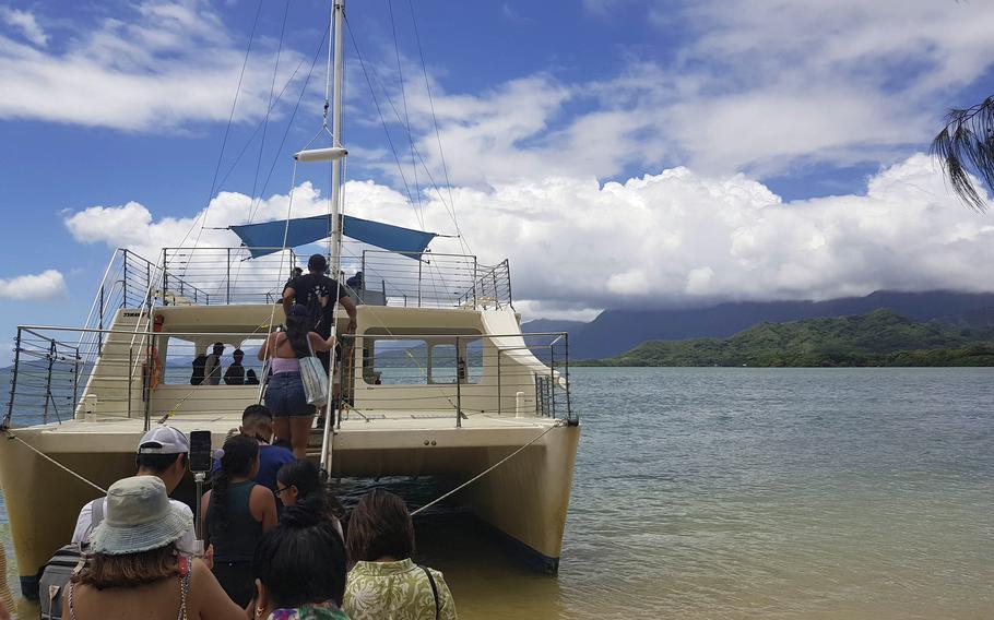 A catamaran takes guests on the Ocean Voyage Tour of the Kua Loa Ranch on the Kāneʻohe Bay, outside the Kua Loa valley of Oahu, Hawaii.