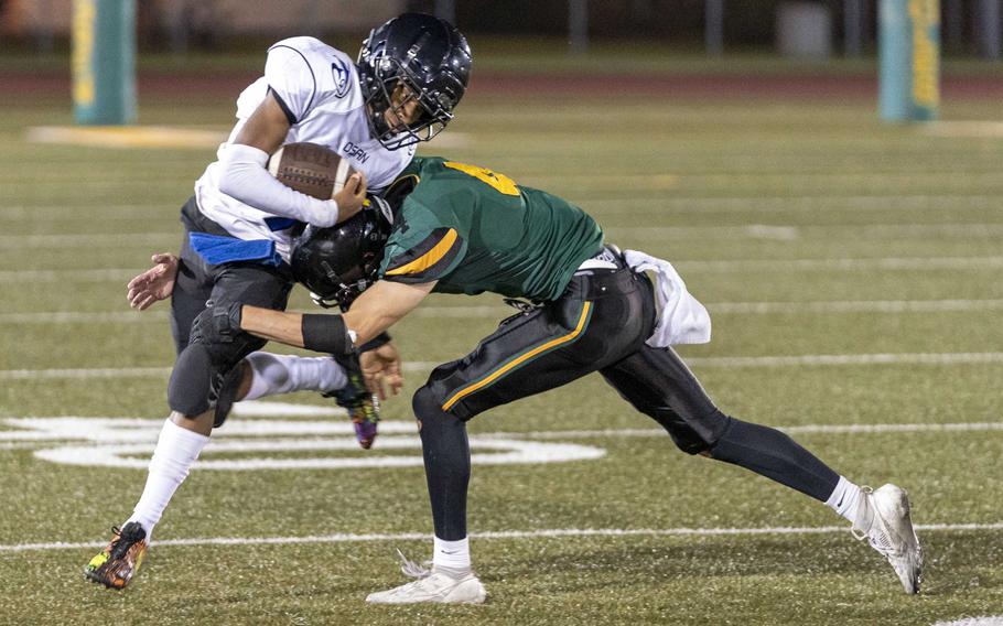 Edgren's Parker Kuns tries to wrestle down Osan's Zeus Queen, who accounted for all the Cougars points in their loss to the Eagles.