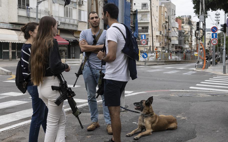 Off-duty Israeli reserve soldiers with their weapons in Tel Aviv in November.