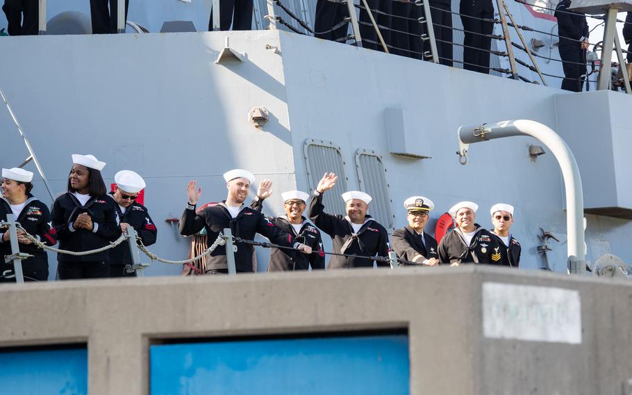 Sailors wave from the USS Stockdale