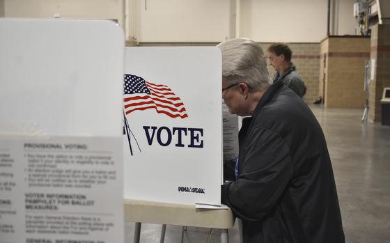 A voter fills out a ballot at the MetraPark events center, Tuesday, June 4, 2024, in Billings, Mont. The primary election will lock in a Republican candidate to challenge three-term incumbent Democratic U.S. Sen. Jon Tester in the November general election. (AP Photo/Matthew Brown) 