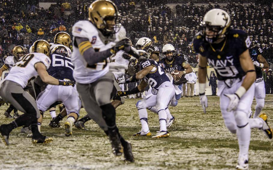 U.S. soldiers and sailors play in the 2013 Army-Navy football game in Philadelphia Dec. 14, 2013. Navy defeated Army,