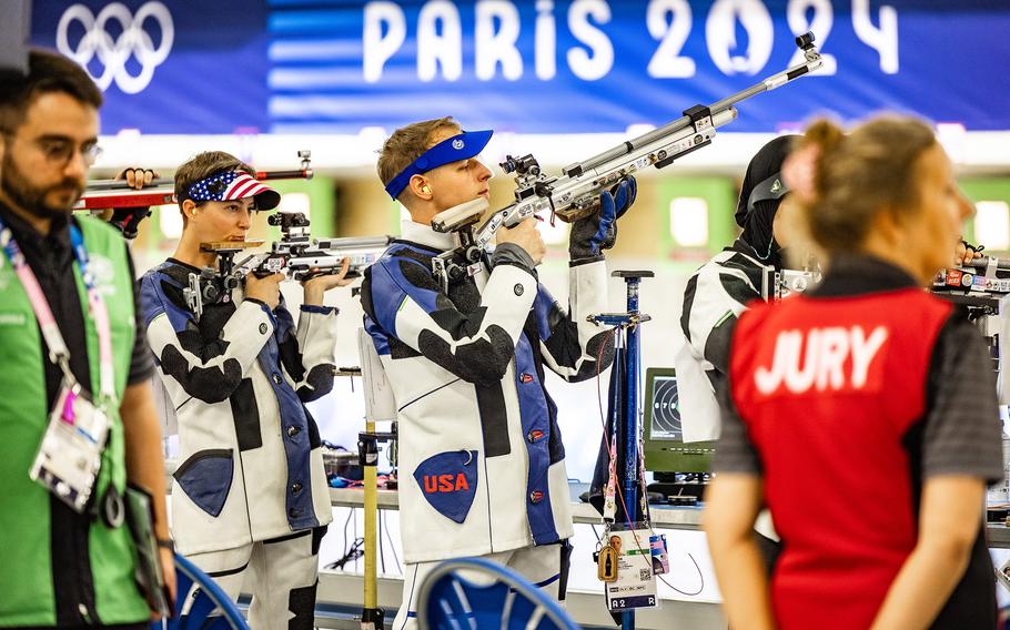 Army Sgt. Ivan Roe adjusts his weapon as Sgt. Sagen Maddalena concentrates during the 10-meter air rifle mixed team competition on Saturday, July 27, 2024, at the Chateauroux Shooting Centre in Deols, France.