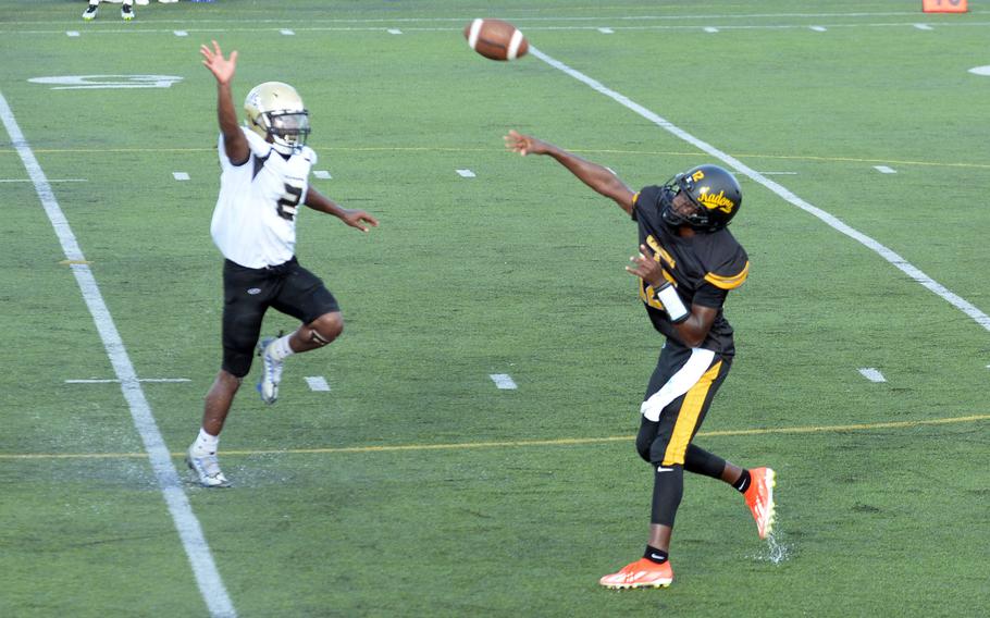 Kadena's DeShaun Nixon fires a pass over outstretched Humphreys defender Matthew Nubin.