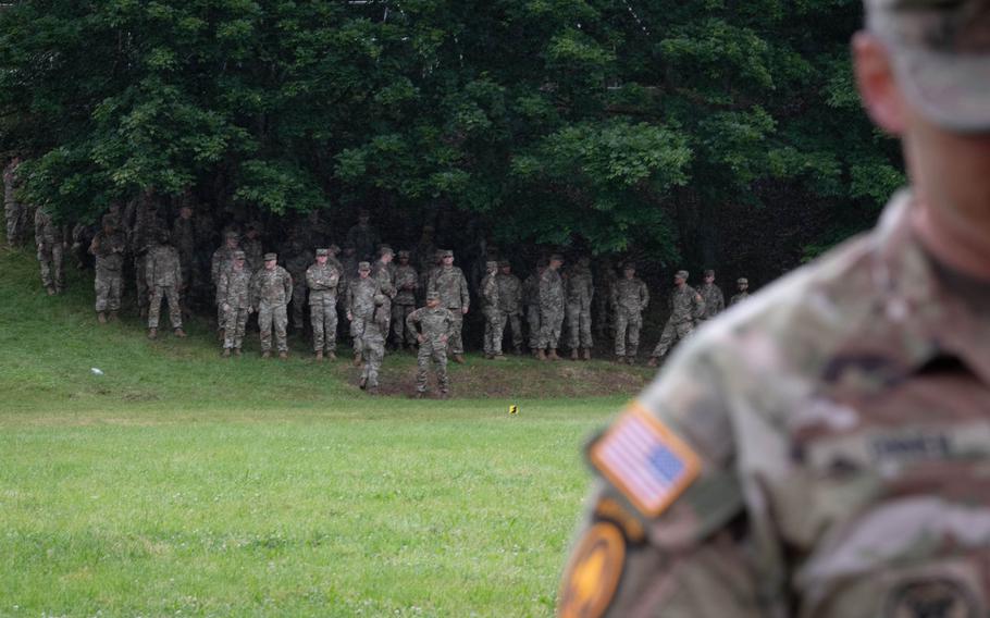 Soldiers assigned to units of the 10th Army Air and Missile Defense Command wait out the rain ahead of a ceremony at Sembach Kaserne, Germany, on June 20, 2024, that saw Brig. Gen. Curtis King assume leadership of the command.