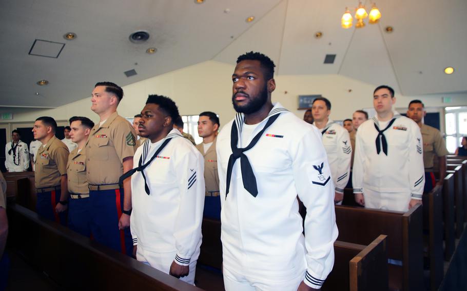 Sailors and Marines stand at attention during the Task Force 76/3 change-of-command ceremony at the Camp Courtney Chapel on Okinawa, Friday, June 9, 2023.