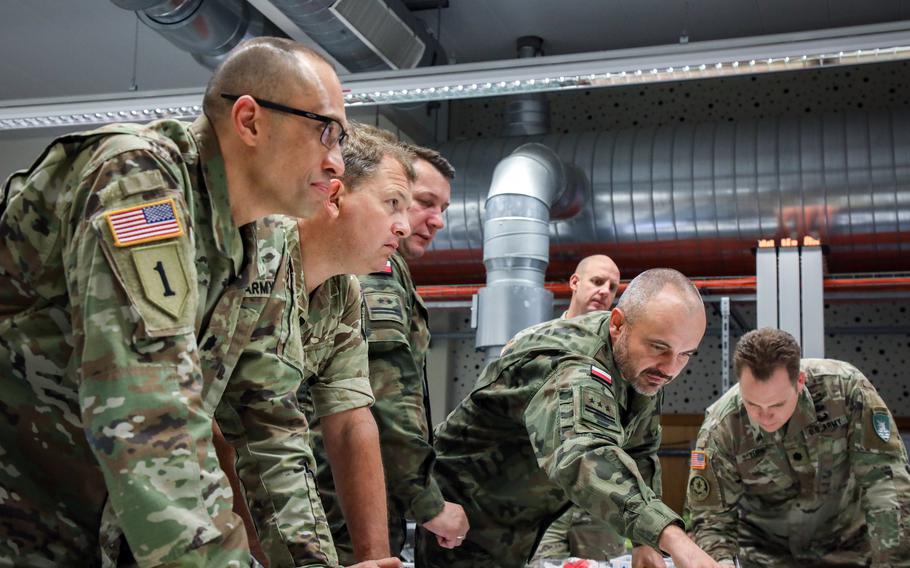 Members of the "white cell" leading Avenger Triad 24 hold a coordination meeting at the Joint Multinational Simulation Center in Grafenwoehr, Germany, on Sept. 17, 2024.