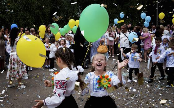 First-graders attend the traditional ceremony for the first day of school in Zaporizhzhia, Ukraine, Sunday Sept. 1, 2024. Zaporizhzhia schoolchildren celebrated the traditional first day of school near the frontline.  (AP Photo/Evgeniy Maloletka)