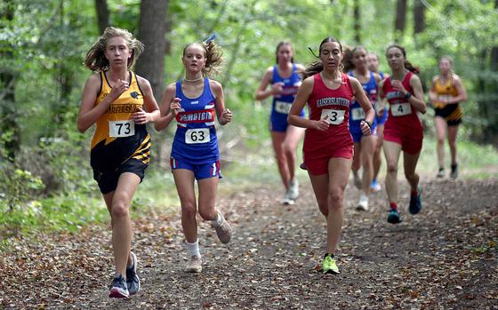 Stuttgart freshman Anna Konon leads a pack that includes Ramstein's Carol Swinson (center left) and Kaiserslautern's Alex Beck (center right) during a cross country meet on Sept. 14, 2024, at Ramstein High School on Ramstein Air Base, Germany.