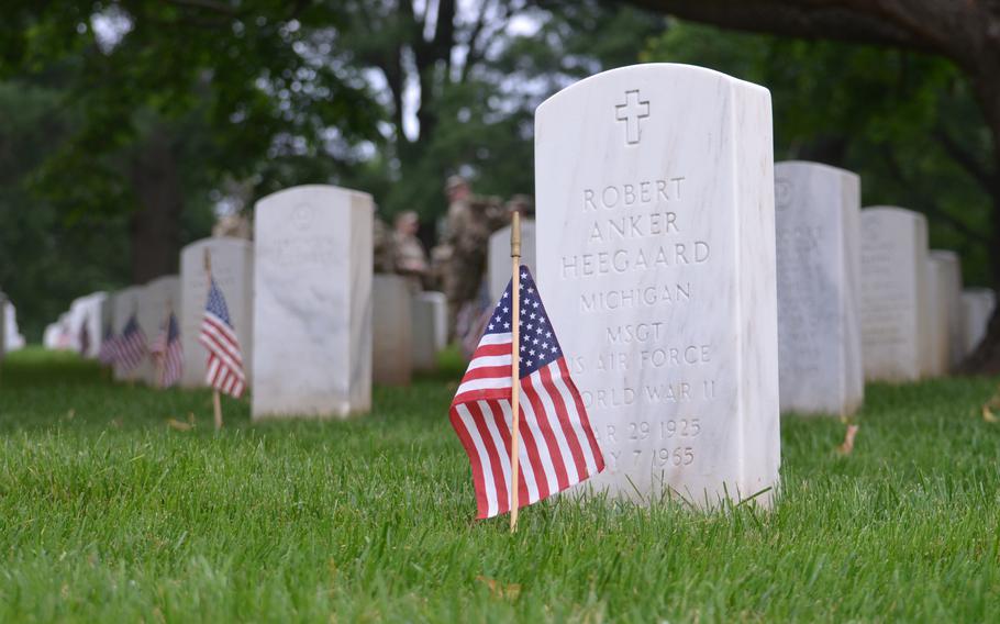 Members of the 3rd Infantry Regiment, also known as The Old Guard, place flags at the graves of those buried at Arlington National Cemetery for “Flags In” on Thursday May 23, 2024, to honor fallen service members for Memorial Day. Soldiers for the annual event place flags in front of more than 260,000 headstones and 7,000 rows in the columbarium.  