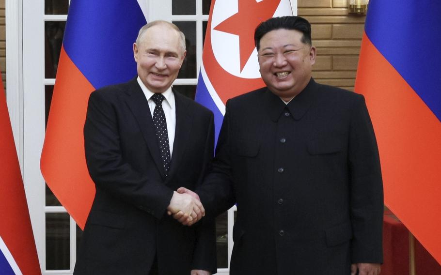 Russian President Vladimir Putin, left, and North Korean leader Kim Jong Un pose for photos after a welcome ceremony in Pyongyang, North Korea, on June 19, 2024.