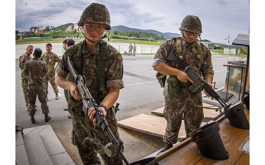 Two South Korean soldiers clear their weapons at an airfield in Yongin, South Korea, Aug. 29, 2016. 